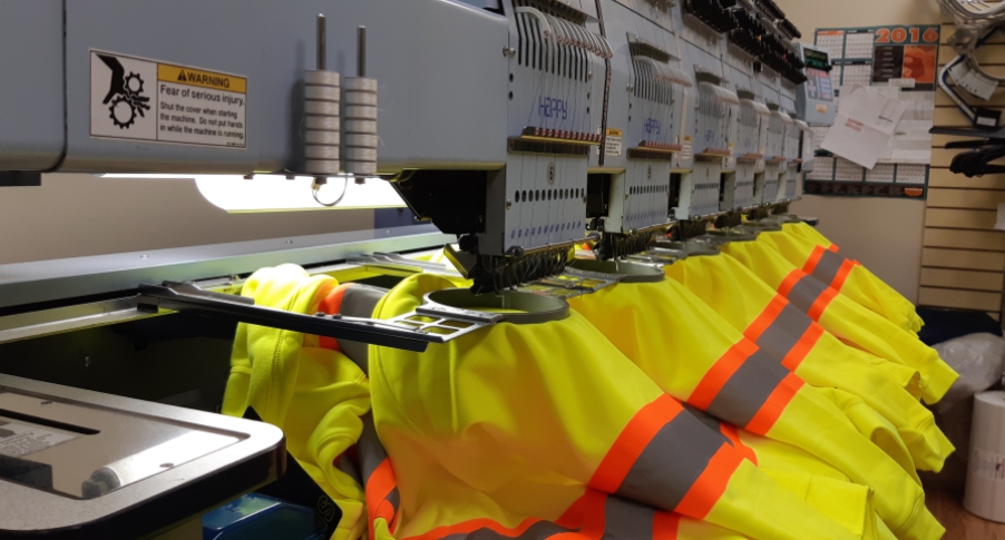 embroidery machines decorating yellow work jackets